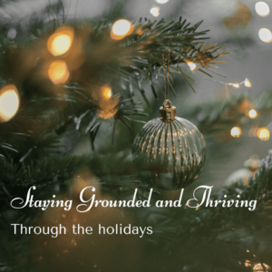 A close-up of a Christmas tree decorated with warm lights and a silver ornament, evoking a sense of calm and reflection during the holiday season. Text reads: 'Staying Grounded and Thriving Through the Holidays.